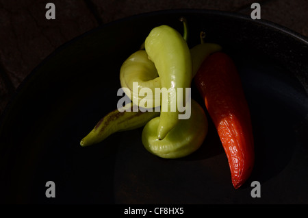 Peperoncini disposti in nero padella di ferro Foto Stock