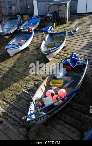 Fascia costiera di granchi e aragoste barche da pesca cazzate fino sul cemento di uno scalo, Sheringham, Norfolk, Regno Unito Foto Stock