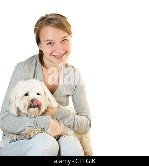 Bella ragazza adolescente holding adorabili coton de tulear cane Foto Stock