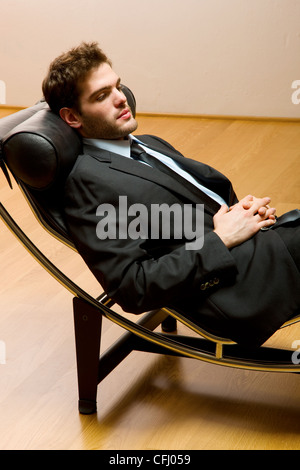 Uomo disteso sulla chaise longue Foto Stock