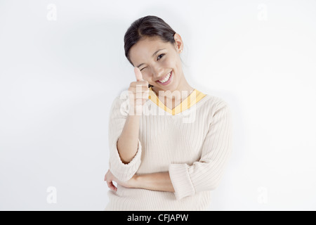 Giovane donna dando un pollice in su Foto Stock