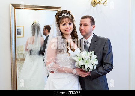 Giovani caucasici di nozze russo giovane in piedi insieme. La riflessione a specchio Foto Stock