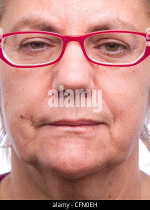 Close up ritratto di una donna di mezza età con moderni occhiali rosso guardando la fotocamera Foto Stock