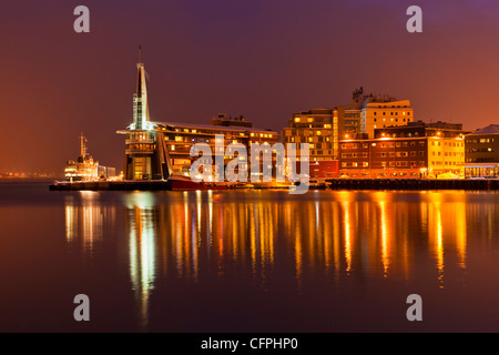 Città artica di Tromso, Porto, porto e waterfront magazzini di notte, Tromso, Troms, Nord della Norvegia, Europa Foto Stock