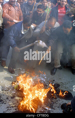 Gli attivisti del Pro-Indian Partito Comunista masterizzare un'effigie in rappresentanza del Presidente USA George Bush come gridano contro di noi gli slogan durante una dimostrazione contro l'esecuzione dell'ex presidente iracheno Saddam Hussain a Srinagar, 30 dicembre 2006. L'India, che aveva legami caldo con il regime iracheno di f Foto Stock