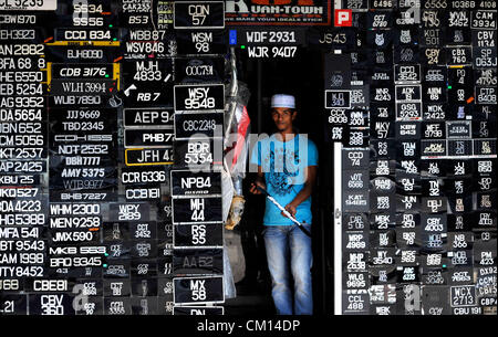 Sett. 11, 2012 - Kuantan, PAHANG, Malesia - un uomo cammina fuori da un lato strada negozio di vendita di targhe in Kuantan, circa 243 chilometri a nord-est di Kuala Lumpur. (Credito Immagine: © Najjua Zulkefli/ZUMAPRESS.com) Foto Stock