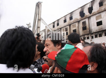 Il presidente del Pakistan Tehreek-e-Insaf (PTI) Imran Khan visite bruciato il sito di fabbrica a Karachi, 13 settembre 2012. Almeno 289 lavoratori in fabbrica sono state bruciate quando il fuoco inghiottito una fabbrica di indumento di mercoledì. Foto Stock