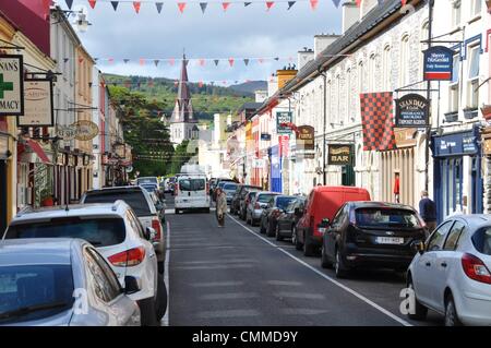 Nella pittoresca cittadina di Kenmare, nella contea di Kerry, Henry Street è una strada trafficata con un sacco di negozi e pub, foto scattata il 27 maggio 2013. La Chiesa cattolica romana la chiesa della Santa Croce (in background) si trova alla fine di Henry Street appena fuori da una piccola piazza. Foto: Frank Baumgart Foto Stock