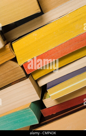 Close-up di pelo di vecchio, indossati i libri tascabili impilati. Angolo di visualizzazione. Pagina dorsali rivolta verso il visualizzatore. Varie le pagine a colori. Foto Stock