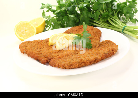 Arrosto di Wiener Schnitzel con fettine di limone e prezzemolo Foto Stock
