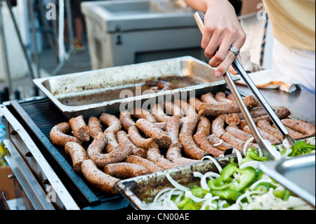 Lo Chef raggiungendo in fette di peperoni verdi e cipolle. Foto Stock