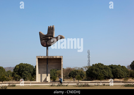 I turisti che visitano la famosa mano aperta di una scultura in un settore di Le Corbusiers moderna città di Chandigarh Punjab India Foto Stock