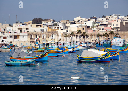 Tradizionali barche da pesca maltesi noto come dghajsa nel porto di Marsaxlokk, Malta Foto Stock