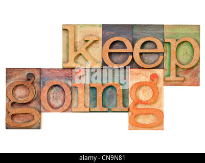 Continuate - motivazione concetto - testo isolato in rilievografia vintage tipo legno Foto Stock