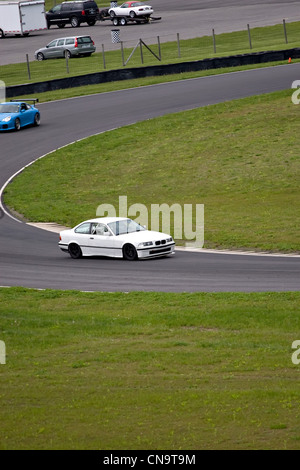 Sports Car racing intorno a un corso su strada a velocità intensa. Foto Stock