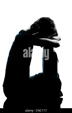 Un caucasian adolescente silhouette ragazza piange triste piena lunghezza in studio ritagliare isolati su sfondo bianco Foto Stock