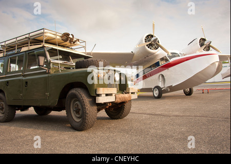 Grumman Goose piano in aeroporto accanto alla serie 2A 1966 Land Rover Foto Stock