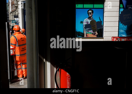 Abbigliamento uomo Hackett negozio di abbigliamento e la costruzione degli operai in London street. Foto Stock