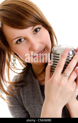 Giovane donna tenendo un retro-microfono. Isolato su bianco. Foto Stock