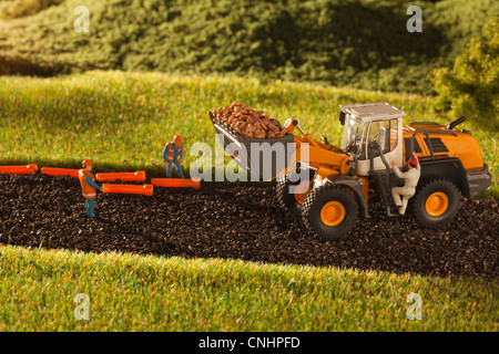 Un diorama di costruzione in miniatura dei lavoratori e un bulldozer Foto Stock