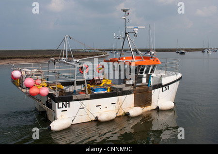 Barca da pesca di lasciare il porto a Wells accanto al mare, Norfolk, East Anglia, Inghilterra. Foto Stock