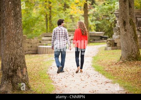 Backview di coppia giovane a piedi attraverso il Parco in autunno, Ontario, Canada Foto Stock