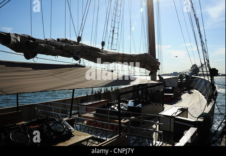 Blue sky deck in legno vista verso la soleggiata archi, Clipper City tour in barca ormeggiata East River, Pier 17, South Street Seaport, New York Foto Stock