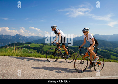 Uomo e donna con bici da corsa su un tour nelle montagne alpine, Austria, Austria superiore, Gmunden Foto Stock