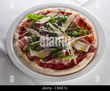 Una Pizza col prosciutto, rucola e formaggio Foto Stock