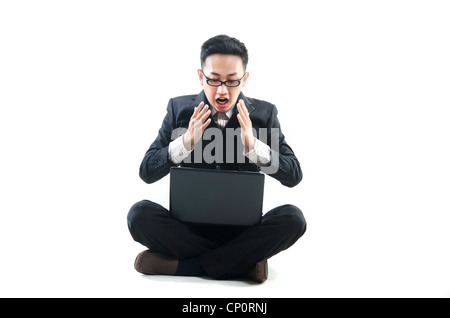 Asian uomo seduto sul pavimento ,scioccato Foto Stock