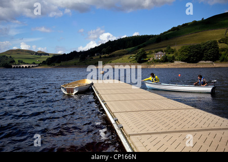 Jetty e barche da pesca sul serbatoio Ladybower , il più basso dei tre nella parte superiore della valle del Derwent nel Derbyshire, Inghilterra. Foto Stock