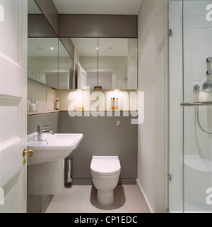 Visualizzare attraverso la porta aperta a montato a parete lavabo e toilette in bagno moderno Foto Stock