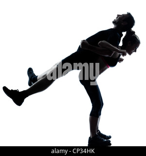 Una giovane donna uomo esercizio di allenamento aerobico postura fitness a piena lunghezza silhouette su studio isolato su sfondo bianco Foto Stock