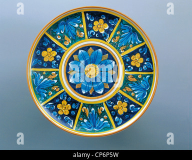 Ceramiche, Italia del XX secolo. Targhetta con bordo giallo con pattern di blu fiori di colore giallo su sfondo blu. Diametro 31 Foto Stock