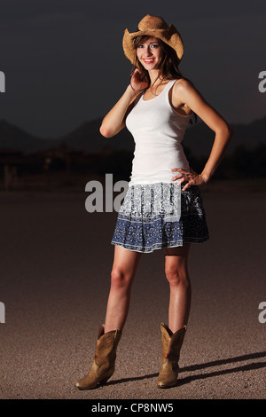 Una giovane e bella modella posa nel deserto Foto Stock