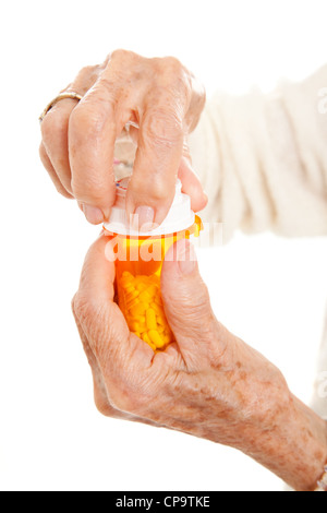 Primo piano della donna senior con le mani in mano cercando di aprire una prescrizione flacone con tappo di sicurezza bambini. Isolato su bianco. Foto Stock