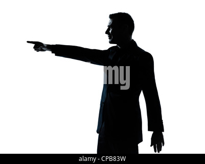 Un caucasian business man poiting ritratto silhouette in studio isolato su sfondo bianco Foto Stock