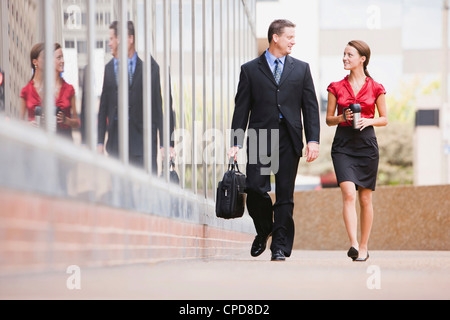 Caucasian co-lavoratori camminare insieme all'aperto Foto Stock