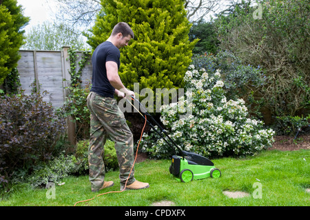 Uomo caucasico la falciatura di prato in giardino a Bristol, Regno Unito Foto Stock