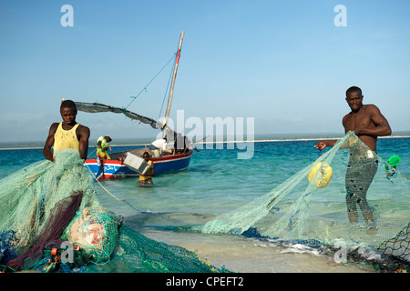 I pescatori tirando le loro reti sulla Mogundula isola nell'arcipelago Quirimbas nel Mozambico settentrionale. Foto Stock