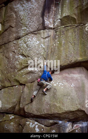 Rocciatore sul crack a Cratcliffe rocce del Peak District, Derbyshire, Regno Unito Foto Stock