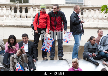 Gli spettatori in attesa dell'arrivo del corteo nuziale del principe William e Kate Middleton a Londra. Foto Stock