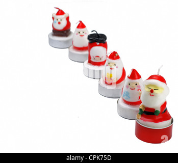 Funny candele di Natale in una riga su sfondo bianco,fuoco selettivo. Foto Stock