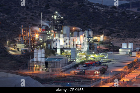 Raffineria di petrolio strutture illuminata di notte Foto Stock