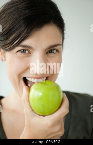 Metà donna adulta di mordere in apple Foto Stock