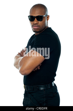Ritratto di agente segreto in piedi con le mani incrociate su sfondo bianco Foto Stock