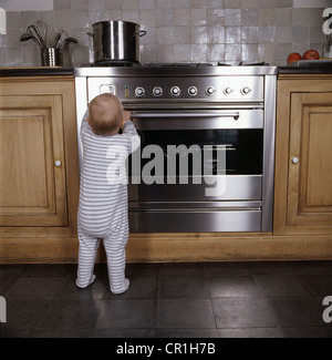 Bambino in piedi da forno in cucina Foto Stock