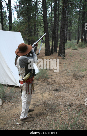 Uomo di montagna si prepara a fuoco moschetto, inizi del XIX secolo Fur Trader ri-enactor, High Desert Museum, Oregon centrale Foto Stock