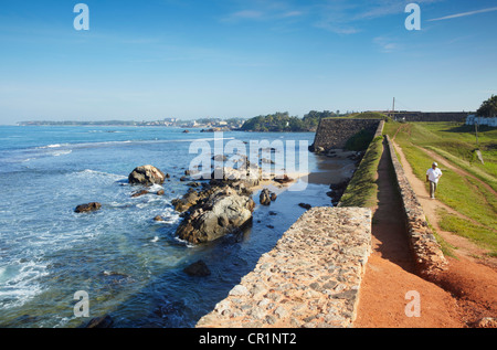 Uomo che cammina sulla Fort bastioni, Galle, sud della provincia, Sri Lanka Foto Stock