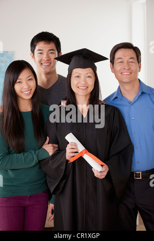 Stati Uniti, California, Los Angeles, ritratto di donna matura in abito di graduazione con la famiglia Foto Stock